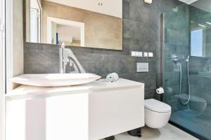 a bathroom with a sink and a toilet and a shower at Stunning sea views pool garden in La Herradura +31 photos