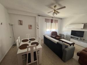 a living room with a couch and a table at La Cuesta House in Castell de Ferro