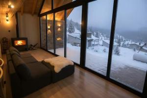 a living room with a couch in front of a window at Cabaña de Montaña, Los Molles - in Los Molles