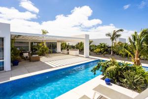 an image of a villa with a swimming pool at Golf Palms in Costa Teguise