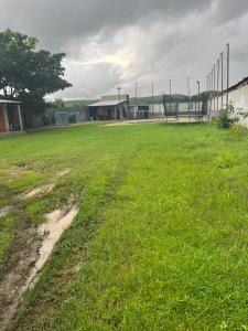 an empty soccer field with a fence in the distance at Chácara Ws in Maceió