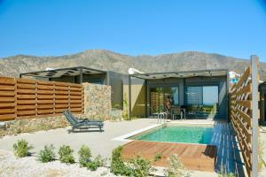a house with a pool and mountains in the background at LIViT Condo Elafonisi in Agios Padeleimon