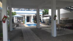 a patio with a pool and tables and chairs at VBM Carangues in Blue Bay