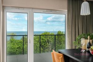 Habitación con puertas correderas de cristal y vistas al océano. en Your Holidays Aquamarina Prima 60, en Międzyzdroje 21 fotos más