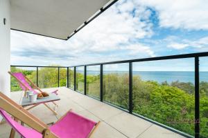 Un balcón con sillas y vista al mar. en Your Holidays Aquamarina Prima 60, en Międzyzdroje