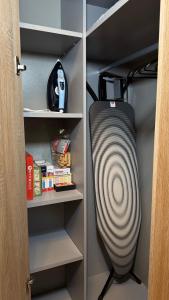 a cupboard with a fan in a closet at Zviedru Nams in Liepāja