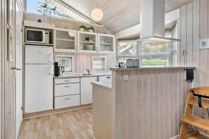 a kitchen with white cabinets and a white refrigerator at 233-Thisted-Tunvej-5 in Thisted +18 photos