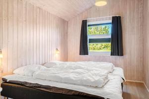 a white bed in a room with a window at 233-Thisted-Tunvej-5 in Thisted