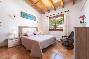 a bedroom with a bed and a window at Finca Kelly in Artá +33 photos