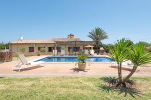 a villa with a swimming pool and a house at Finca Kelly in Artá
