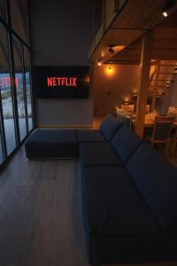 a living room with a couch in front of a netflix sign at Cabaña de Montaña, Los Molles - in Los Molles