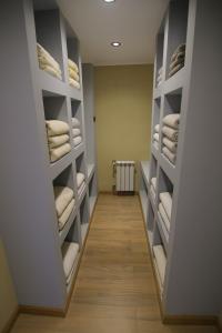 a walk in closet with white towels on shelves at Cabaña de Montaña, Los Molles - in Los Molles