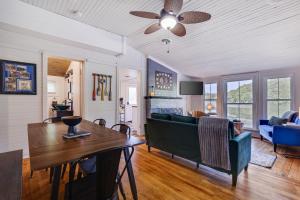a living room with a table and a couch at Heart's Desire, Cottage with stunning lake views in Effort