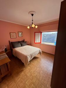 a bedroom with a large bed and a window at Casa La Peña in Luarca +7 photos