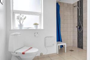 a white bathroom with a toilet and a window at 618-Thisted-Fiskervej-82 in Thisted +15 photos