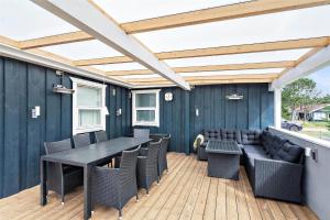 a patio with a table and chairs on a deck at 618-Thisted-Fiskervej-82 in Thisted