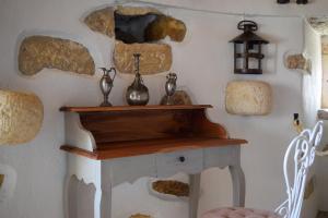 a living room with a fireplace with rocks on the wall at Moinho das Longas in Montelavar