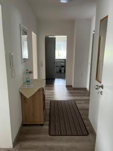 a hallway of an apartment with a table and a door at Schloßberg Ferienwohnung in Waldeck