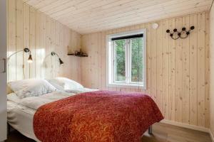 une chambre avec un lit avec une couverture rouge et une fenêtre dans l'établissement 1028-Thisted-Tingbakken-28, à Torsted 17 autres photos