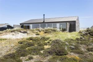 a house on top of a hill with grass at 768-Snedsted-Somaerkevej-68 in Snedsted