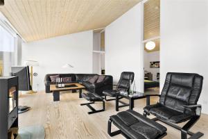 a living room with black leather chairs and a couch at 768-Snedsted-Somaerkevej-68 in Snedsted