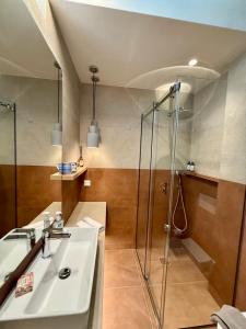 a bathroom with a sink and a shower at Diana Seaside Apartment in Anavissos