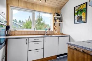 a kitchen with white cabinets and a window at 512-Thisted-Sotungevej-4 in Thisted