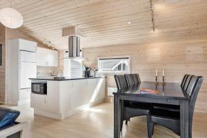 a kitchen with a table and a kitchen with a counter at 980-Thisted-Spanggardsvej-35 in Torsted +17 photos