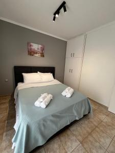 a bedroom with a bed with two towels on it at Elonia Apartment in Polygryos