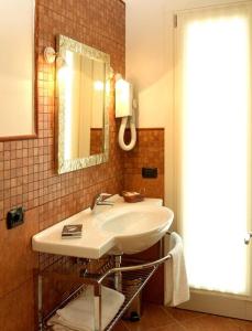 a bathroom with a sink and a mirror at Albergo Corte di Emma in Arzignano