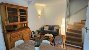 a living room with a table and a couch at Les Platanes in Yvoire