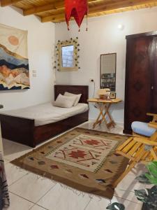 a bedroom with a bed and a table and a rug at Light House studio in Dahab