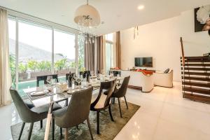 a dining room with a long table and chairs at Serenity Saigon Sky Villas - Free One Way Airport Shuttle in Ho Chi Minh City