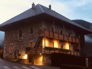a large stone building with lights on at Savoie détendre in Bellecombe-en-Beauges