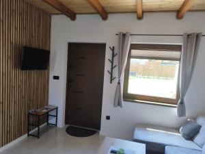 a living room with a couch and a window at Dychnij Se in Myczków