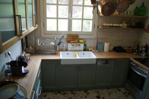 a kitchen with a sink and a counter top at Villa Trypiti in Limenaria