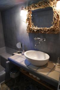 a bathroom with a sink and a mirror on a counter at Villa Trypiti in Limenaria +10 photos
