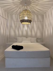 a bedroom with a large bed with a chandelier at Value for money Naousa Center designer spacious room in Naousa