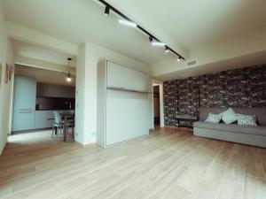 a living room with a couch and a table at Fiore di Langa - Residence in Monforte d'Alba in Monforte dʼAlba