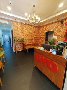 a lobby of a restaurant with a brick wall at J Hotel Masjid India KL in Kuala Lumpur