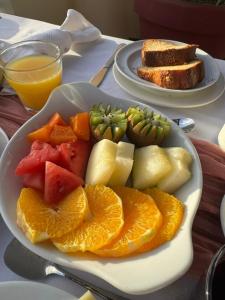 a plate of fruits and vegetables on a table at Hotel Por Do Sol in Tarrafal +26 photos