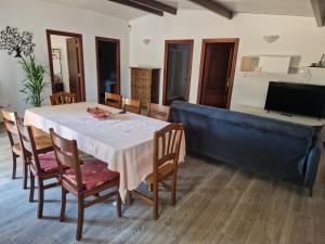 a dining room with a table and chairs and a television at La Cabaña in Redondela