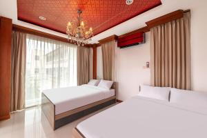 a bedroom with two beds and a chandelier at Luxury Pure Modern Pool Villa 5Bed KTV Gym Nr BTS&Central in Bangkok +32 photos