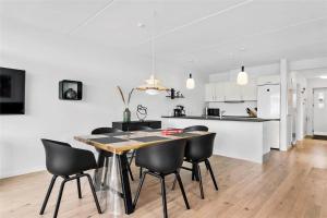 a kitchen and dining room with a table and chairs at 785-Thisted-Havstokken-32-A in Thisted +21 photos
