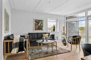 a living room with a couch and a table at 785-Thisted-Havstokken-32-A in Thisted