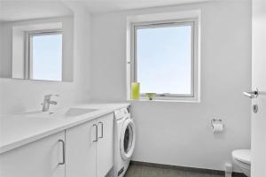 a white bathroom with a sink and a washing machine at 785-Thisted-Havstokken-32-A in Thisted