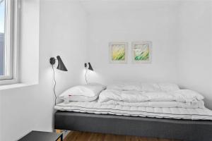 a white bedroom with a bed with white sheets at 785-Thisted-Havstokken-32-A in Thisted