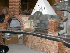 a brick oven with a stone wall with a stove at Hotel Brilliantin in Sliven
