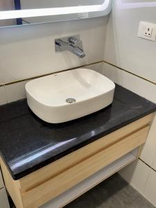 a white sink on a counter in a bathroom at KANHA RETREAT - Vrindavan in Vrindāvan +46 photos