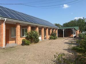 a brick house with solar panels on its roof at Klever-ok in Nerubayskoye